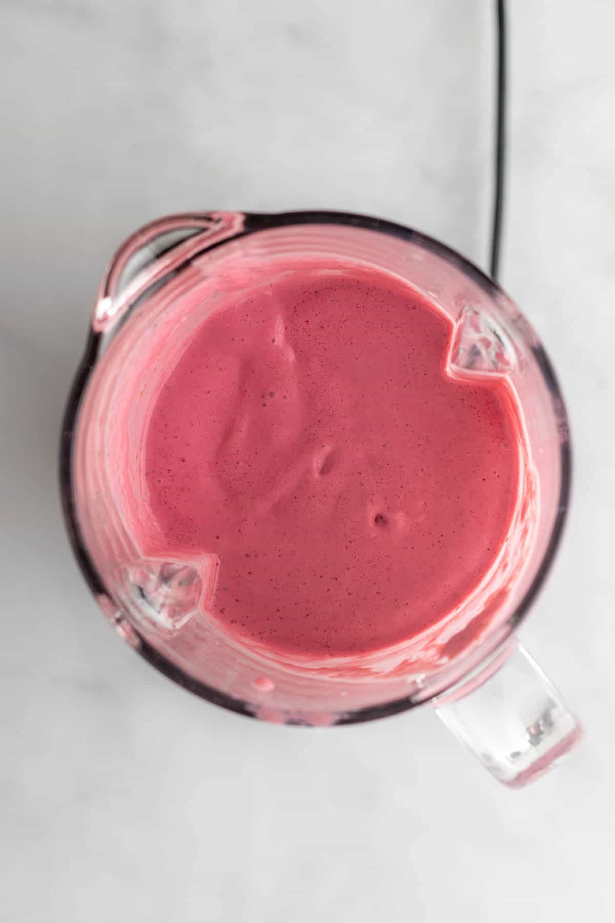 Smoothie ingredients blended in a blender, as seen from above