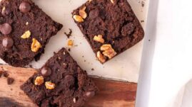 Sweet potato brownies cut into squares on a decorative cutting board