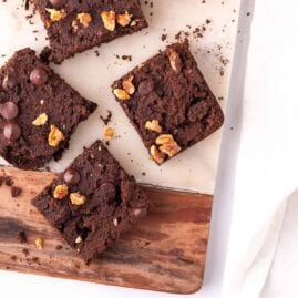 Sweet potato brownies cut into squares on a decorative cutting board