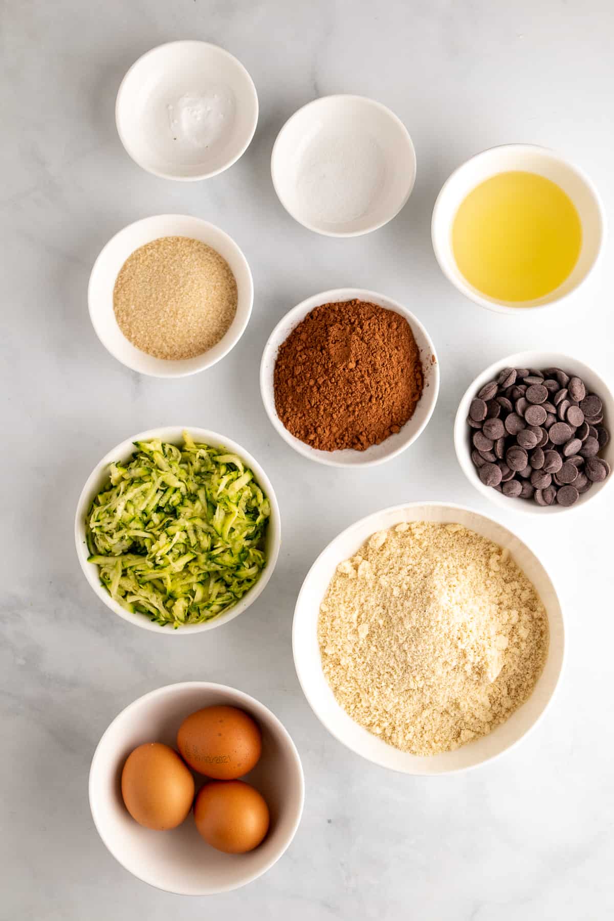 Muffin ingredients in separate bowls and ramekins, as seen from above