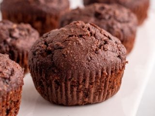 Closeup of zucchini muffins on a white serving tray