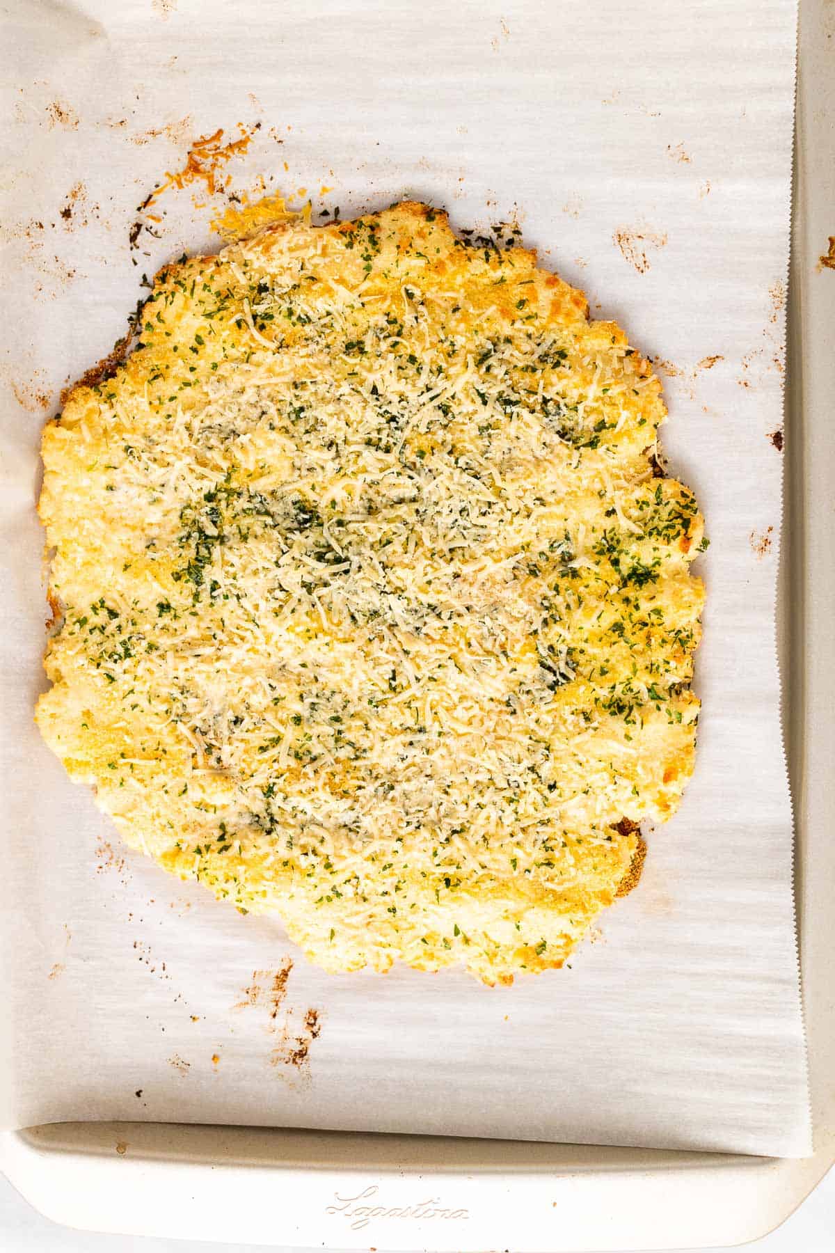 Finished garlic bread sitting on a baking sheet lined with parchment paper, as seen from above