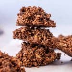 Stack of three keto no bake cookies surrounded by more cookies