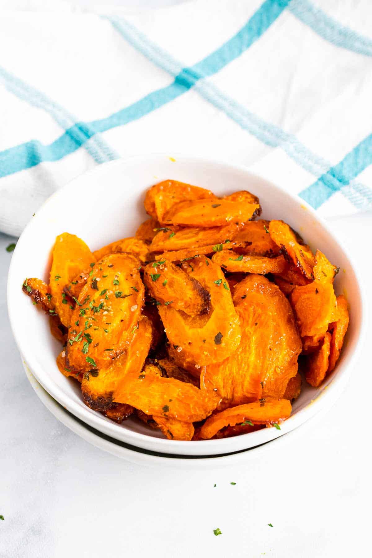 Close-up of roasted carrot slices in a white bowl