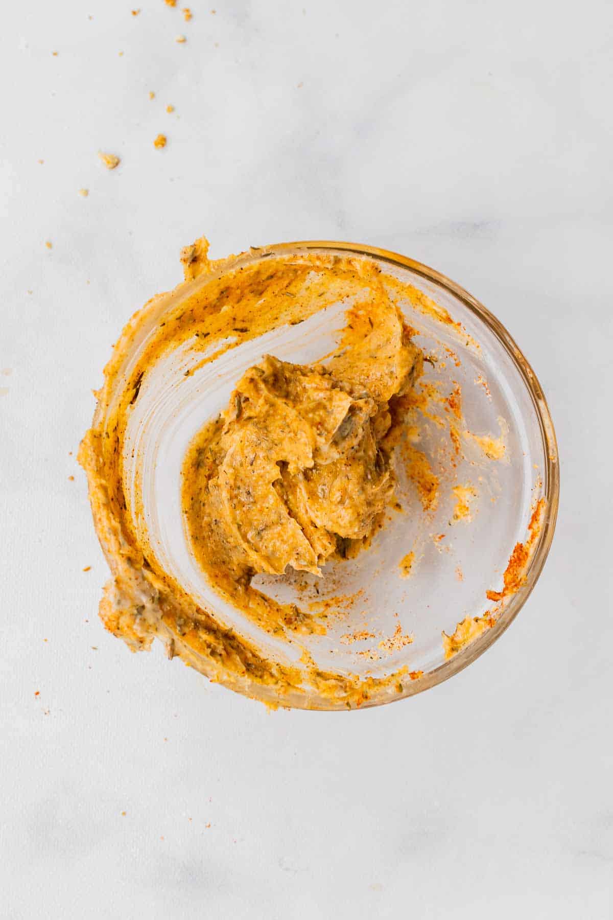 Butter, salt, dried thyme, garlic powder, paprika, and pepper combined into a paste in a ramekin