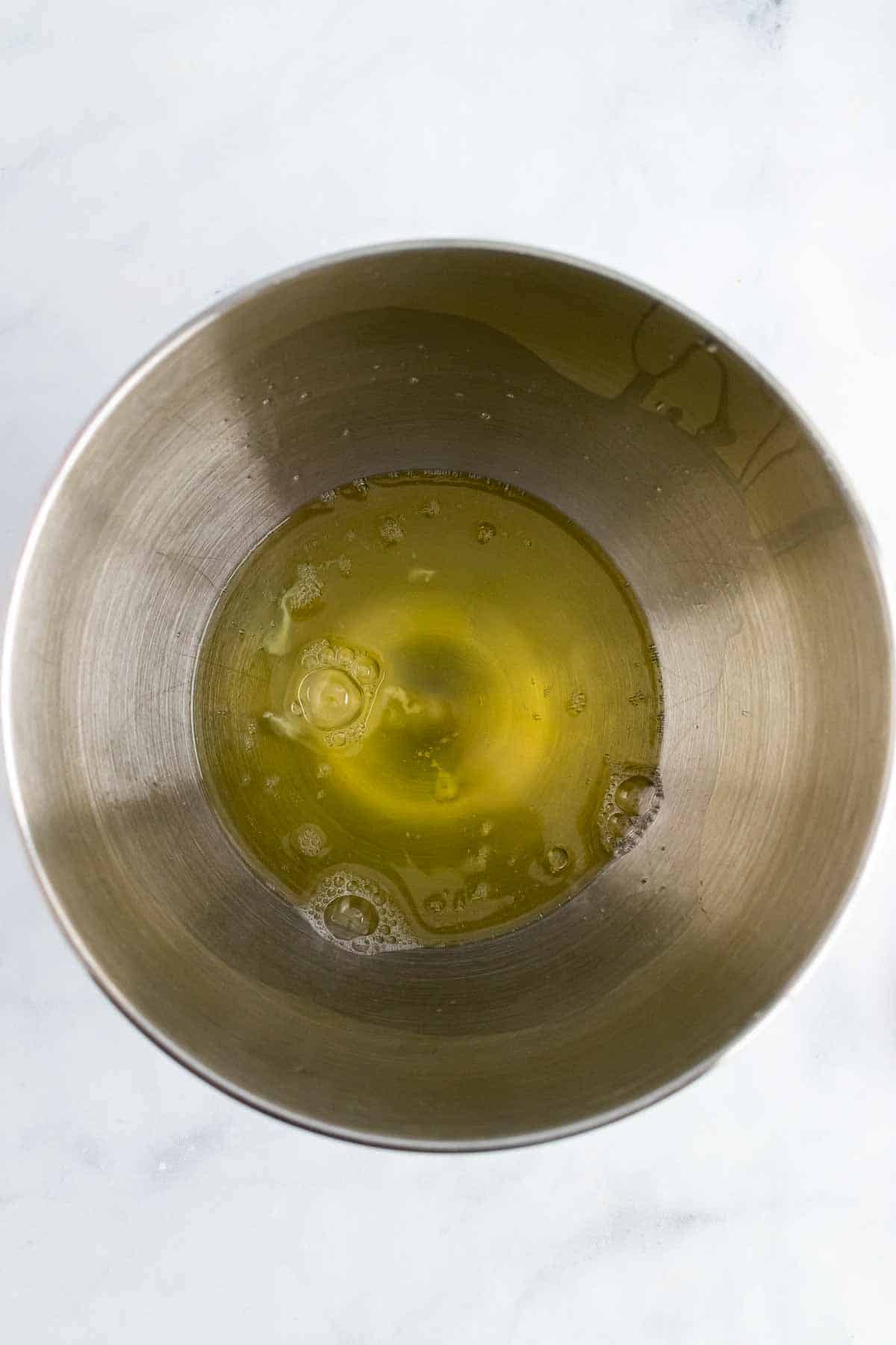 Egg whites in the bowl of a stand mixer, as seen from above