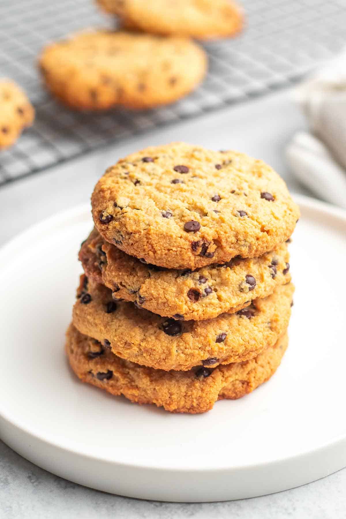 Stack of four Cream Cheese Chocolate Chip Cookies on a white plate