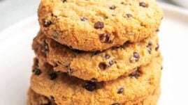 Stack of four Cream Cheese Chocolate Chip Cookies on a white plate