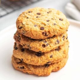Stack of four Cream Cheese Chocolate Chip Cookies on a white plate