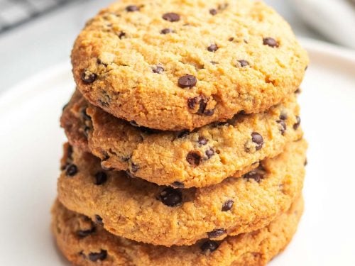 Stack of four Cream Cheese Chocolate Chip Cookies on a white plate