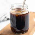 Sugar free teriyaki sauce in a glass mason jar with a metal spoon
