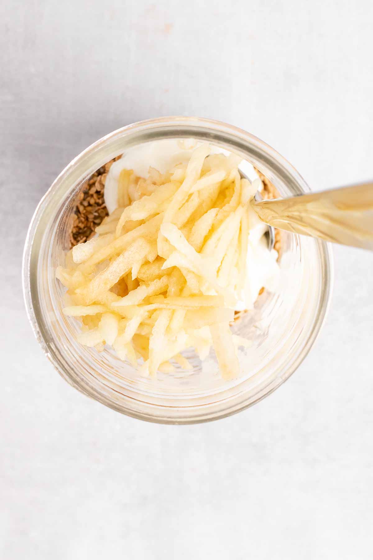 Shredded apple and greek yogurt added to the jar, as seen from above