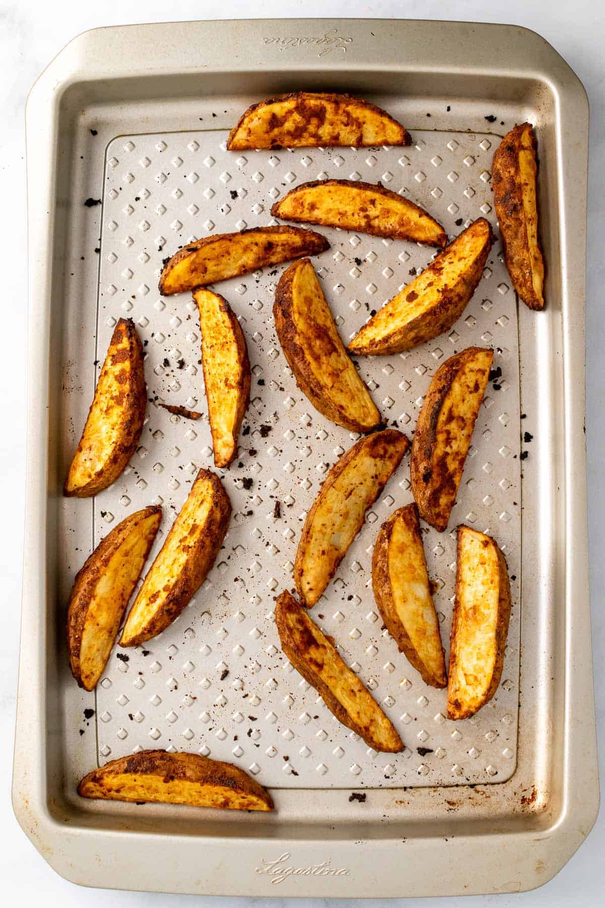 Baked French fries on a aluminum baking sheet