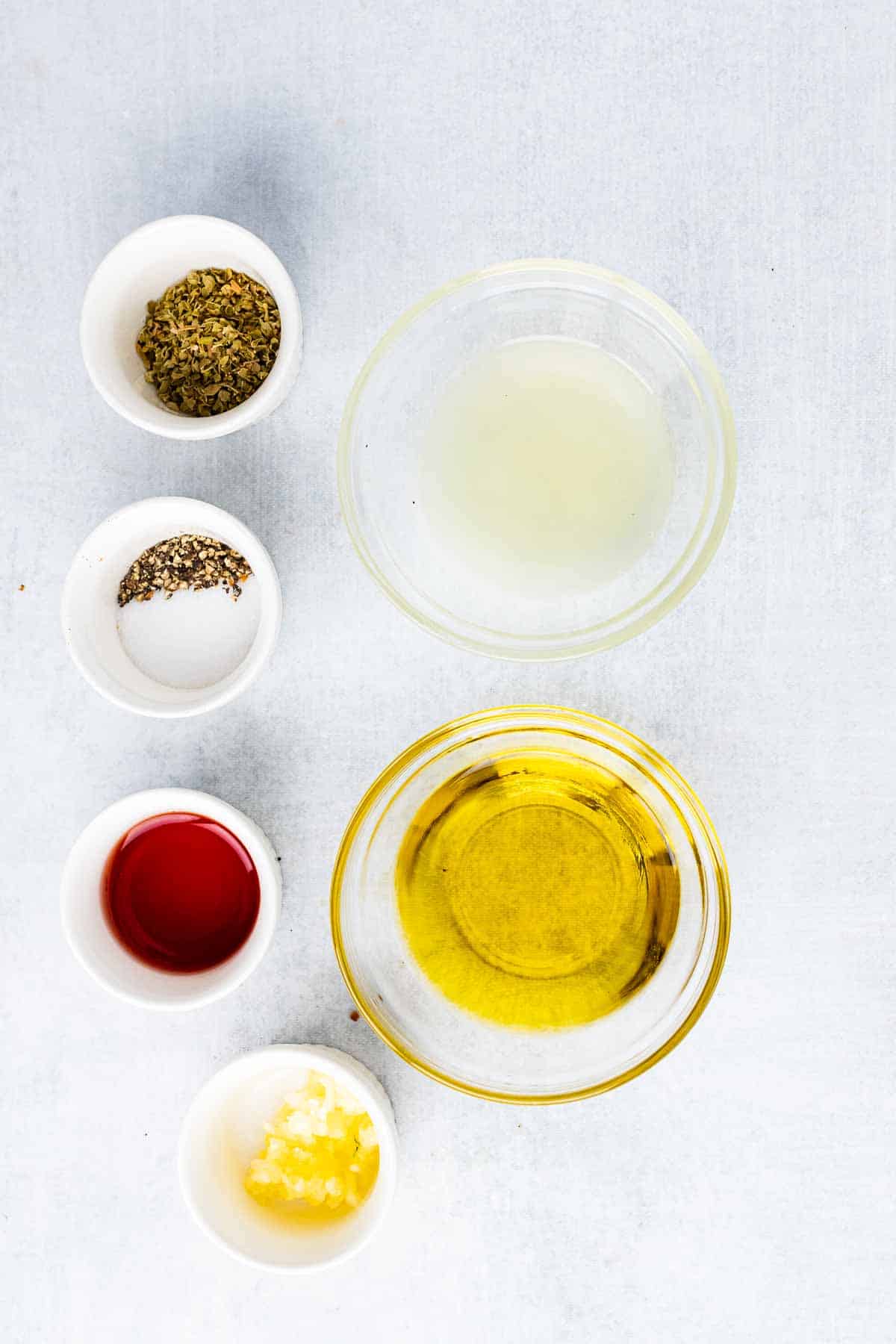 Vinaigrette ingredients in individual bowls on table