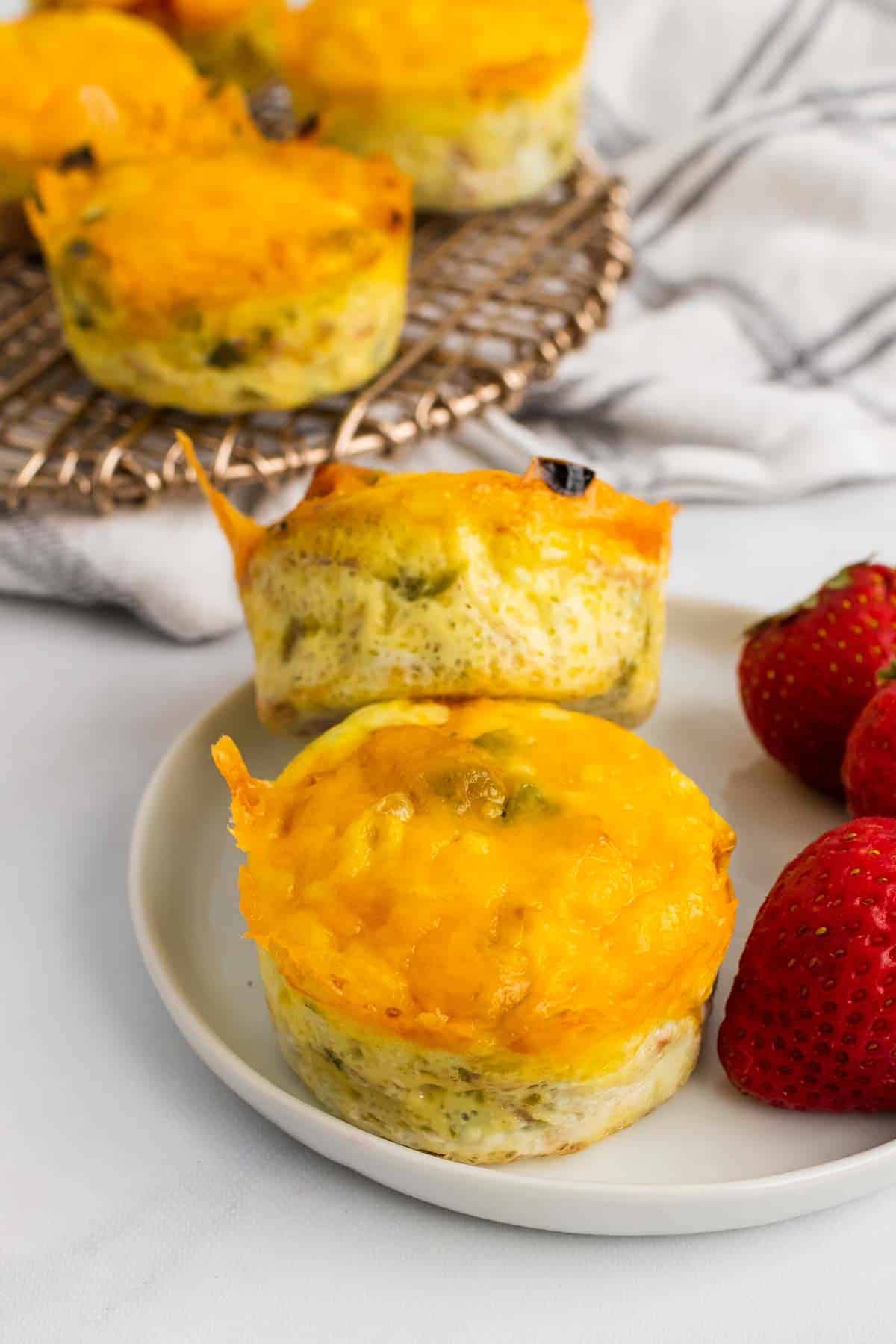 Plate with two egg muffins and strawberries