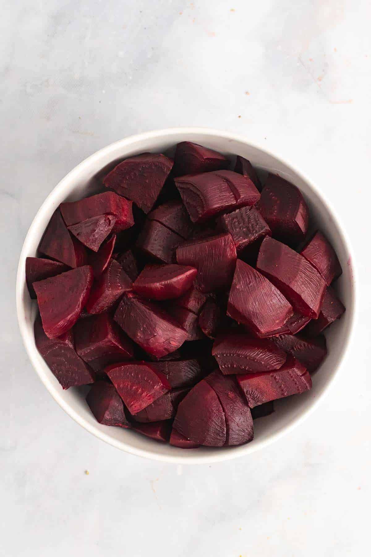 Diced beets in a white bowl