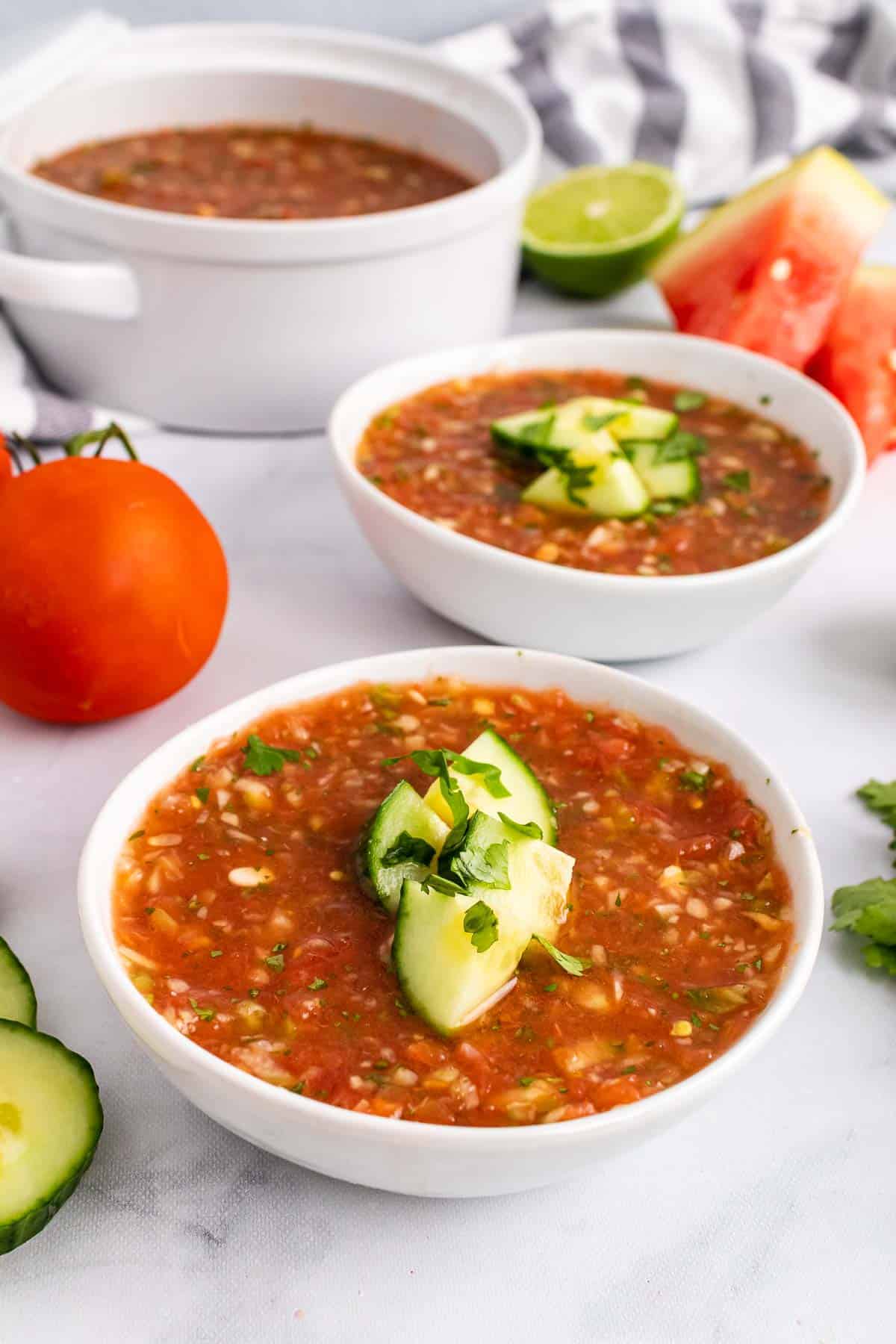Two bowls of Grilled Watermelon Gazpacho on table 