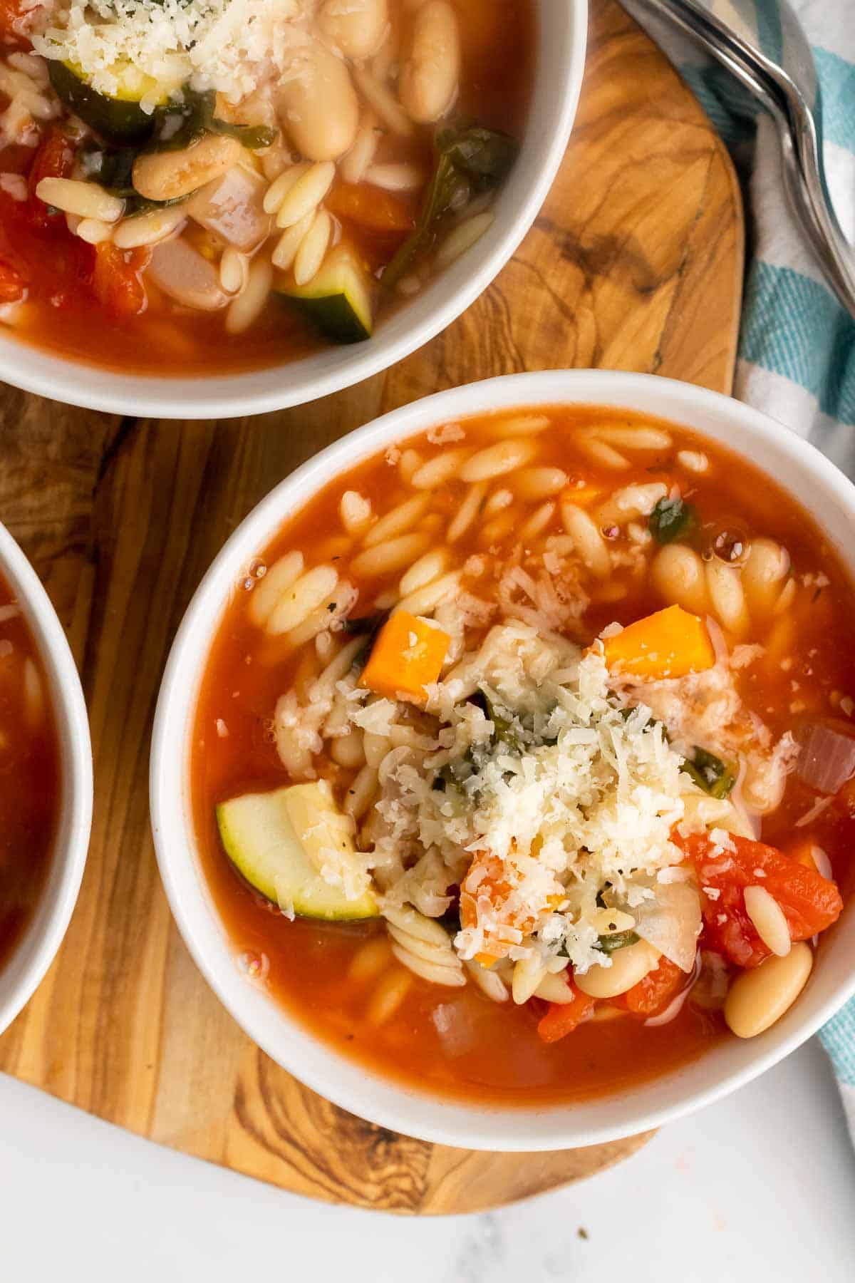 Bowl of slow cooker minestrone with grated cheese on top