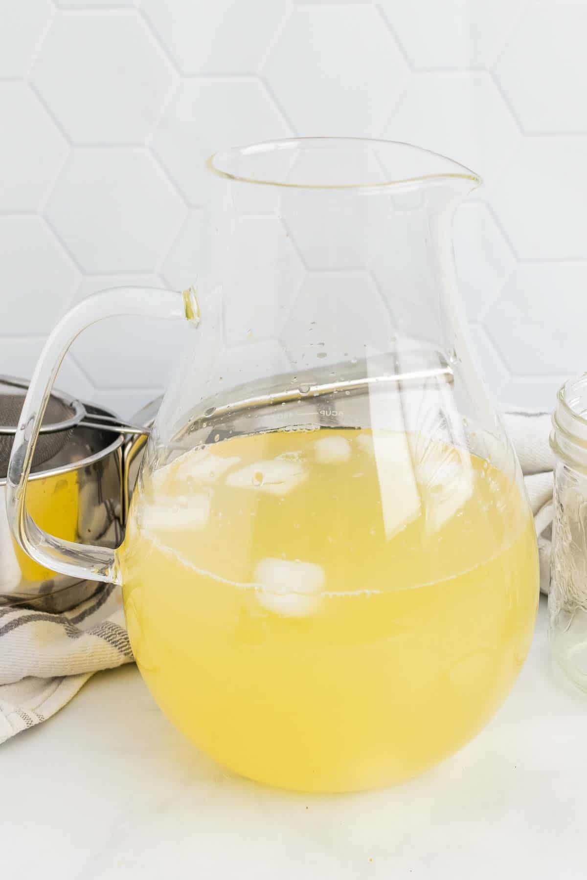 Pitcher with lemonade and ice cubes