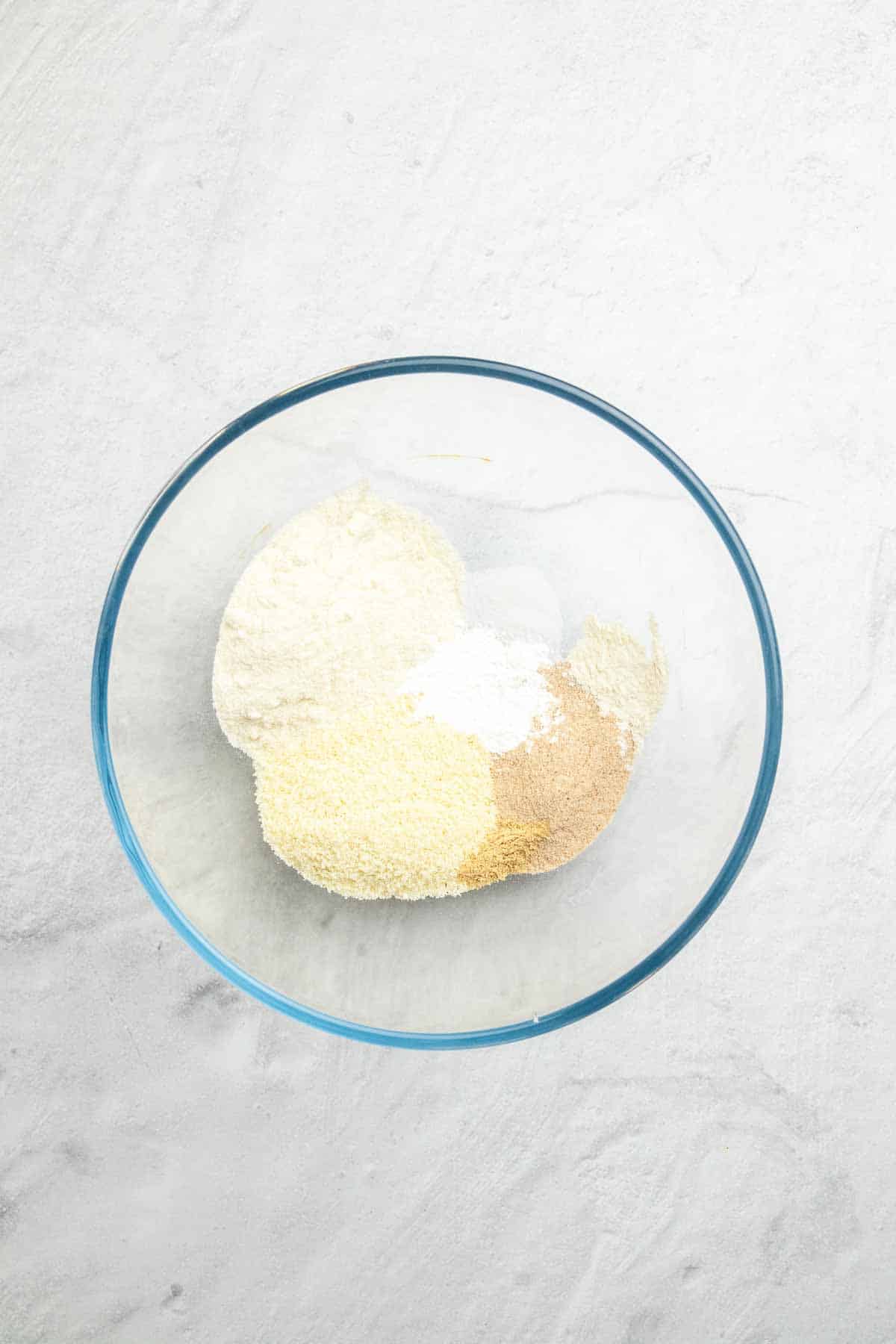 Dry ingredients in a glass bowl, as seen from above