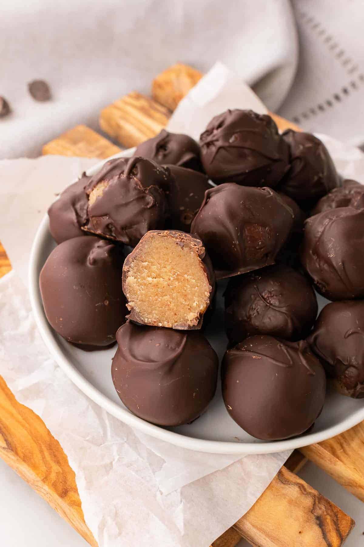 Stack of almond truffles on a white plate