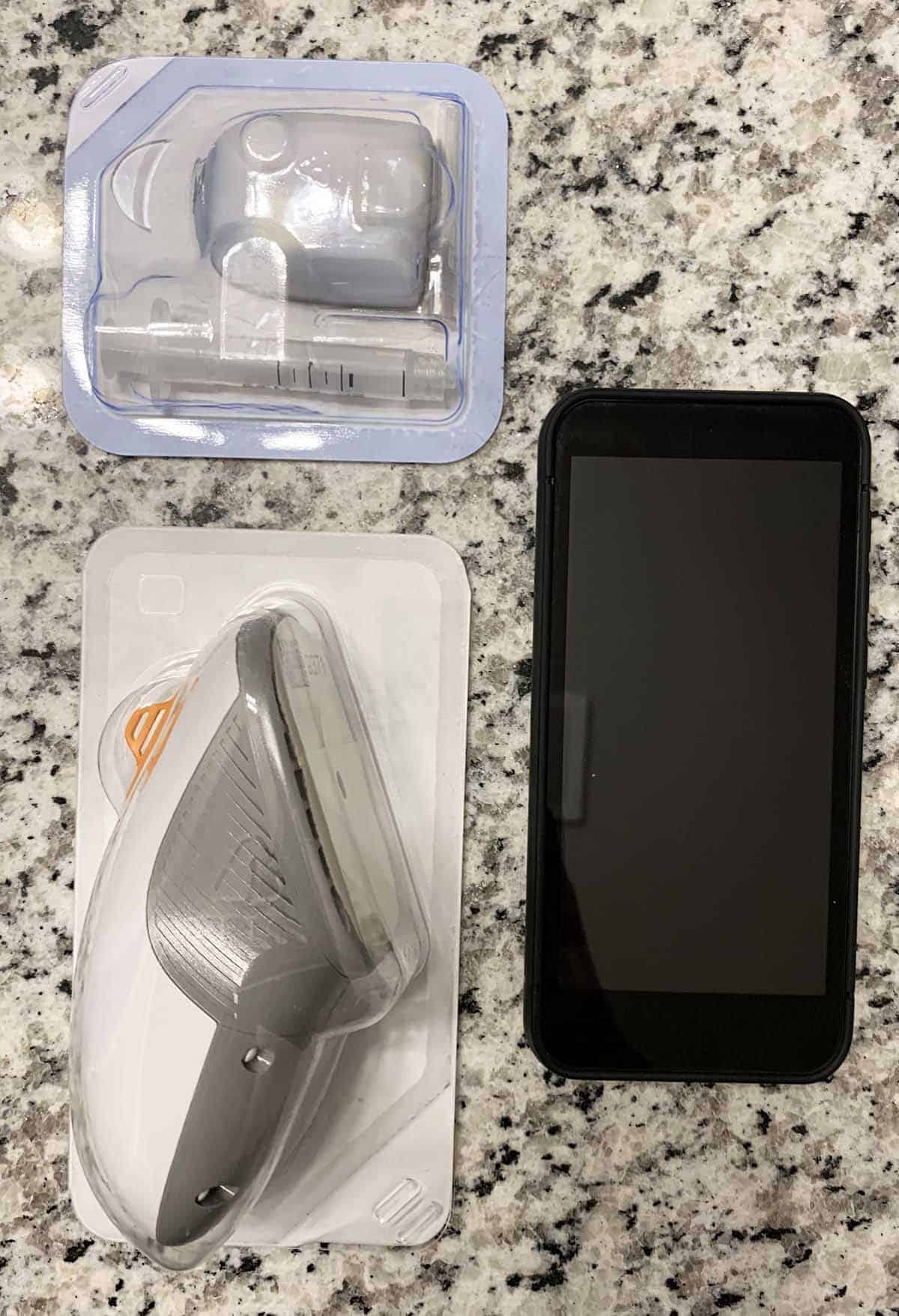 Omnipod 5, Dexcom 6 CGM, and an mobile phone on a table