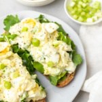 Low sodium egg salad served on two pieces of toast with lettuce on a white plate