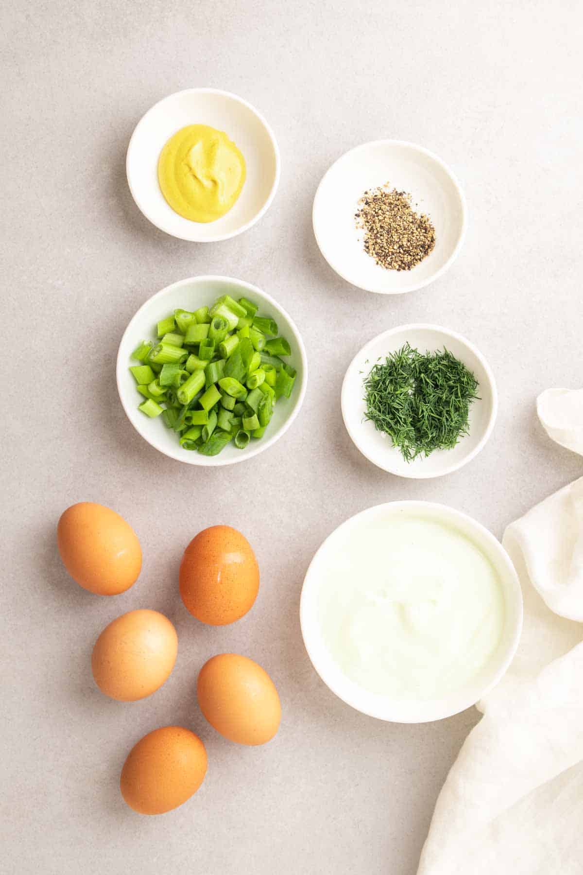 Ingredients for recipe in separate bowls and ramekins, as seen from above