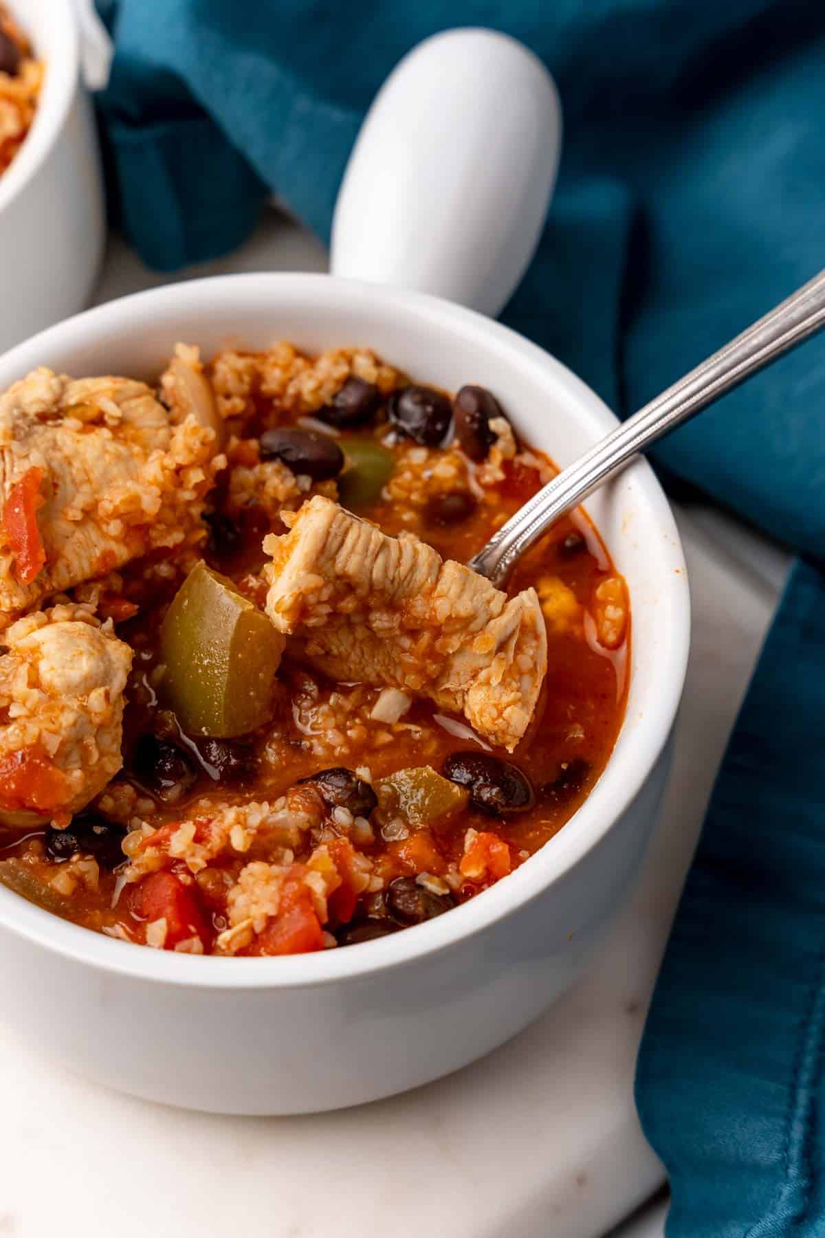 Black Bean Chicken Chili with Bulgur in white bowl with spoon