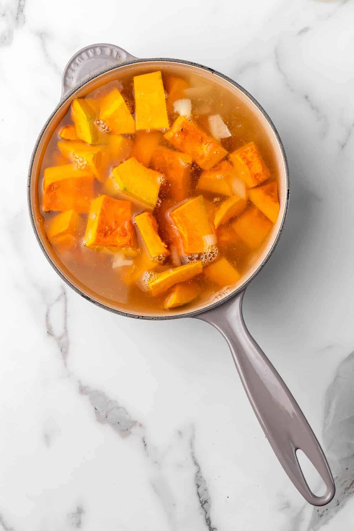 Buttercup squash and stock cooking in a pot
