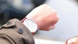 Man looking at watch to decide when to take metformin