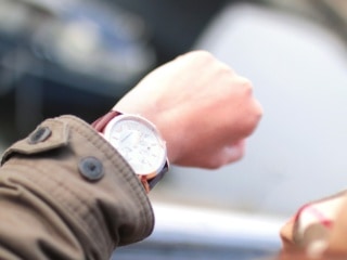 Man looking at watch to decide when to take metformin