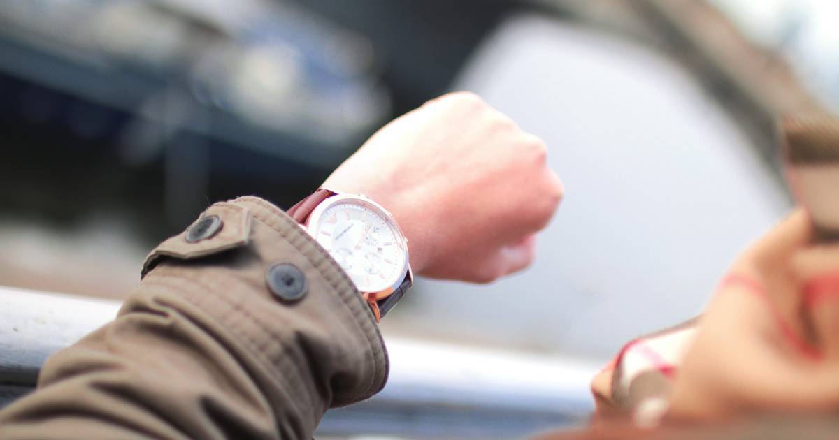 Man looking at watch to decide when to take metformin