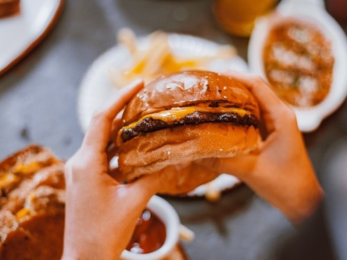 Hands holding burger