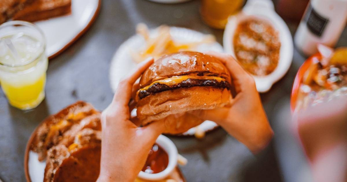 Hands holding burger