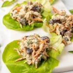 Closeup angle view of four lettuce leaves with chicken salad inside