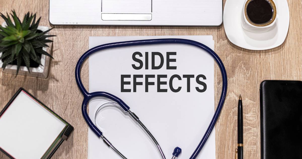 The words side effects on a piece of paper on a doctor's desk