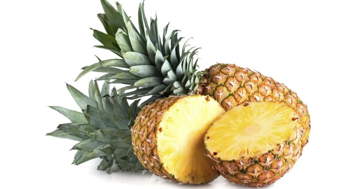 Two pineapples. One is sliced in half.