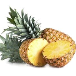 Two pineapples. One is sliced in half.