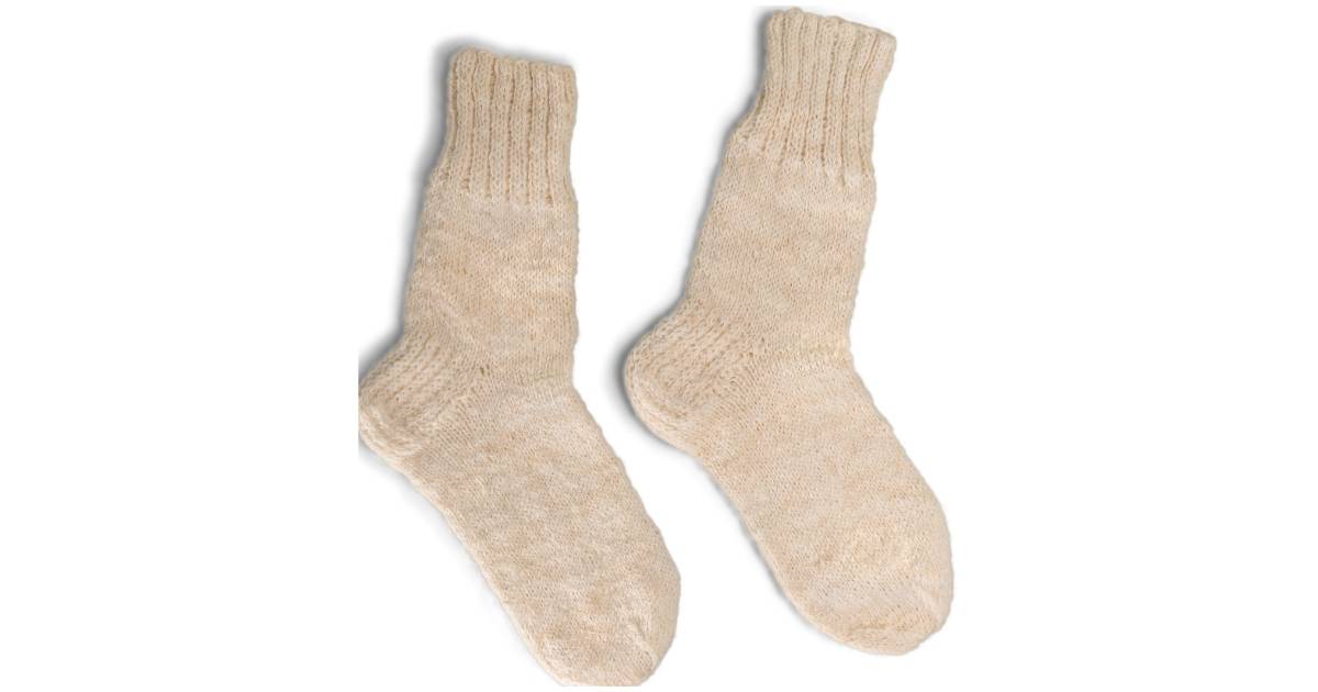 A pair of cream colored wool socks