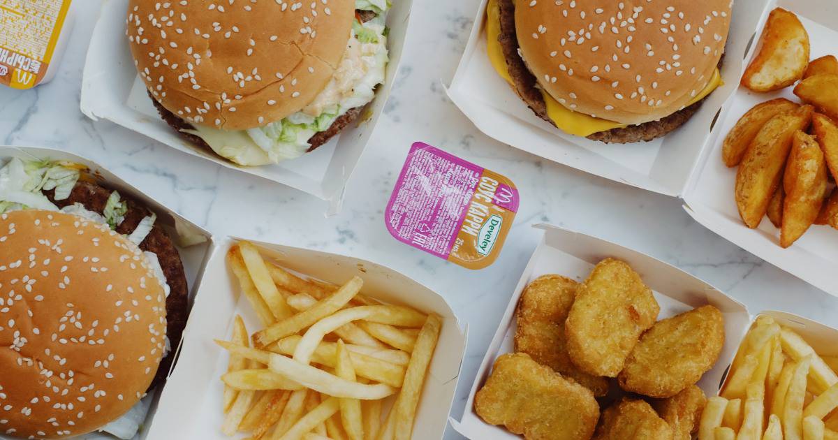 Overhead shot of a hamburger, chicken tenders, and french fries.