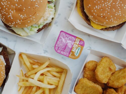 Overhead shot of a hamburger, chicken tenders, and french fries.