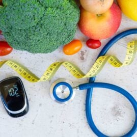 Image of fruit, vegetables, glucose reader, and measuring tape