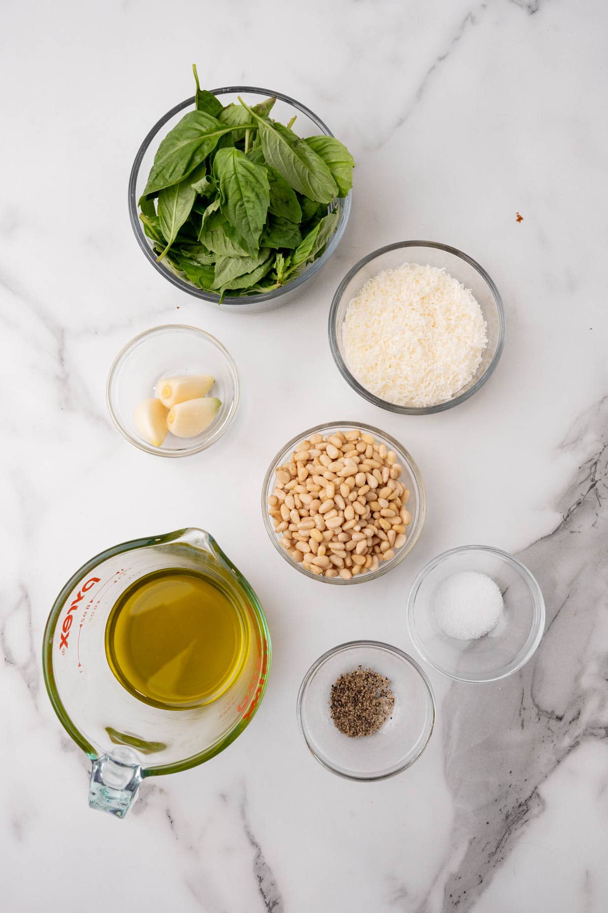 Ingredients for pesto on a marble surface