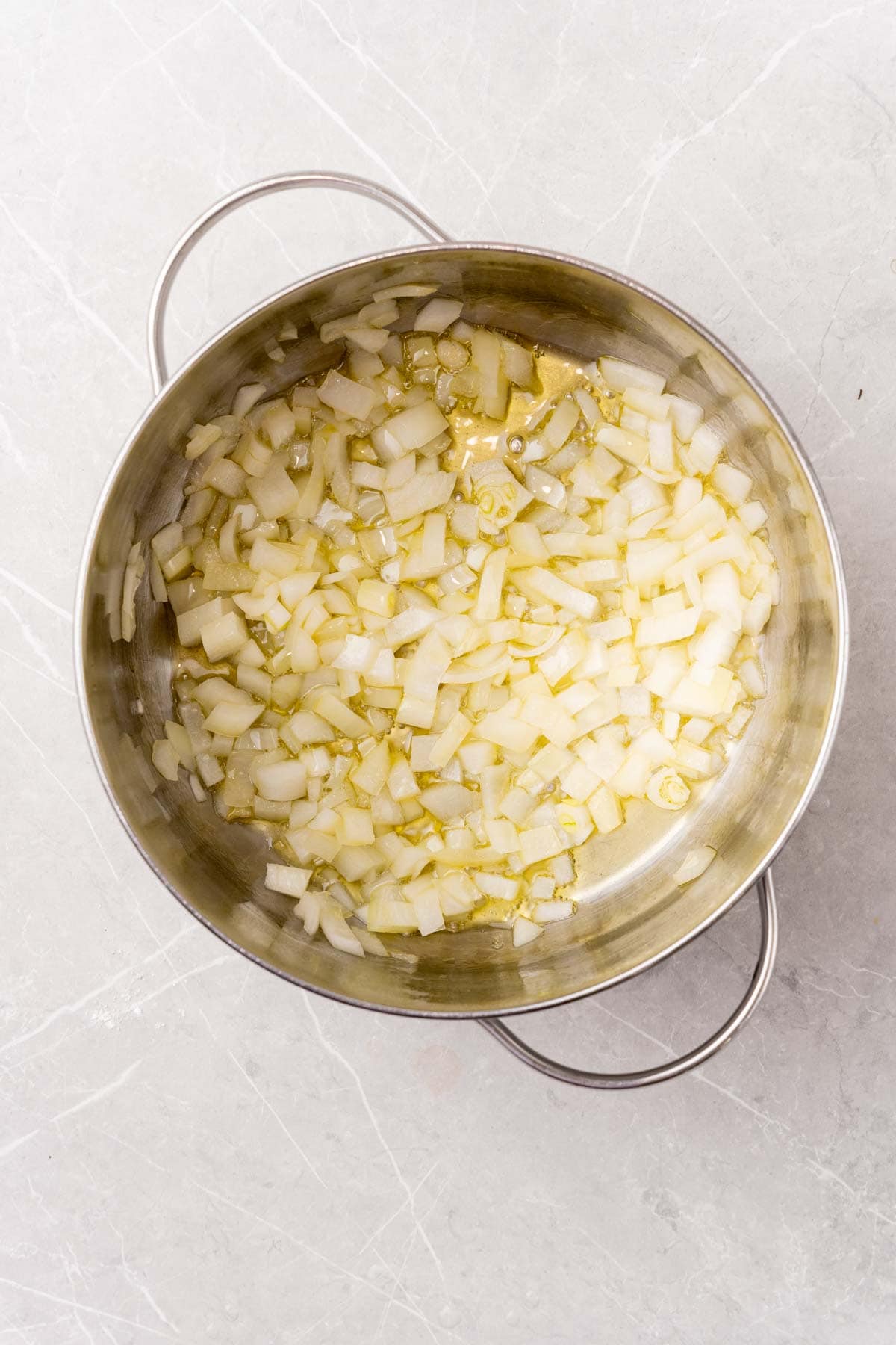 Minced onion sauteing in a pot