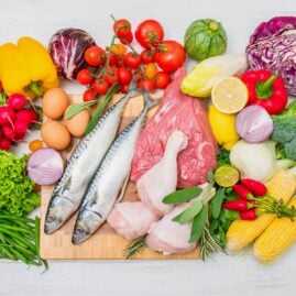 A variety of Mediterranean diet foods on a cutting board