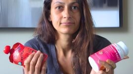 Woman holding glucose tabs and fruit pouch