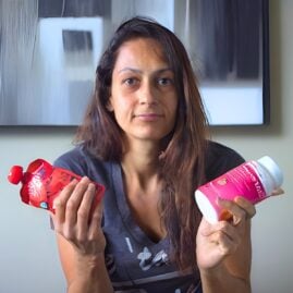 Woman holding glucose tabs and fruit pouch